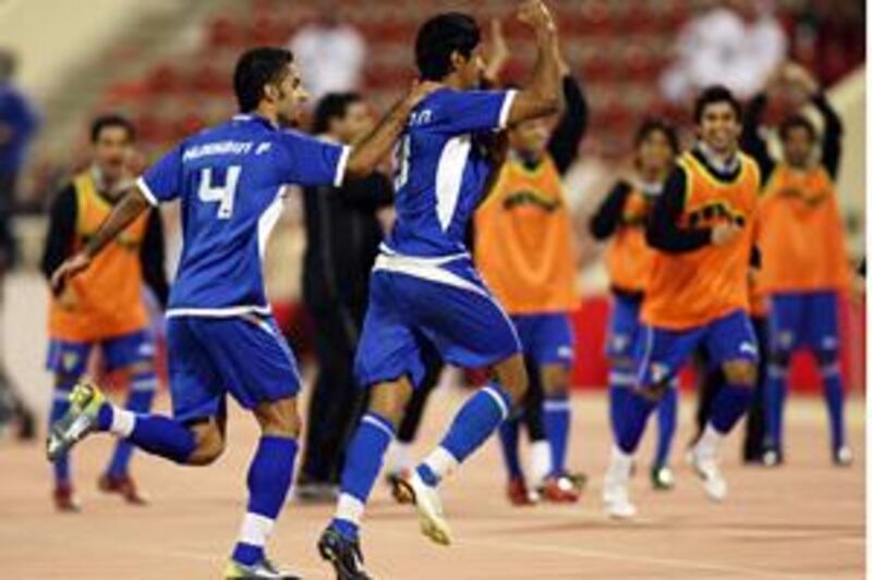 Kuwait's Mesaad Nada, right, celebrates with his teammate Hussain Ali after scoring the only goal of the game against Bahrain.