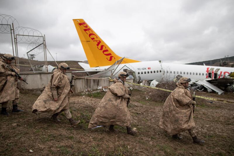 Turkish soldiers secure the wreckage after a Pegasus Airlines aircraft skidded off the Sabiha Goekcen airport runway in Istanbul, Turkey.  EPA