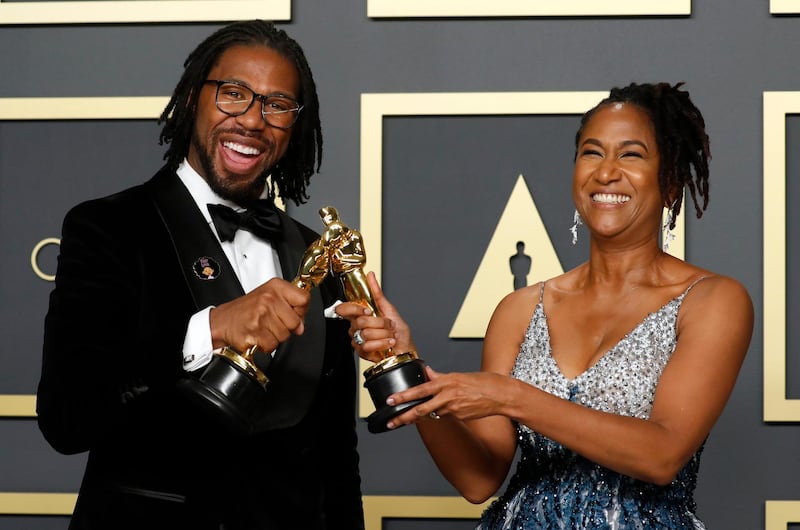 Matthew A. Cherry and Karen Rupert Toliver pose with the Oscar for Best Animated Short Film for 'Hair Love' at the 92nd Academy Awards on Sunday, February 9. Reuters
