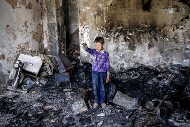 An Afghan child stands in his damaged room a day after a suicide attack and gunfight in Kabul. EPA