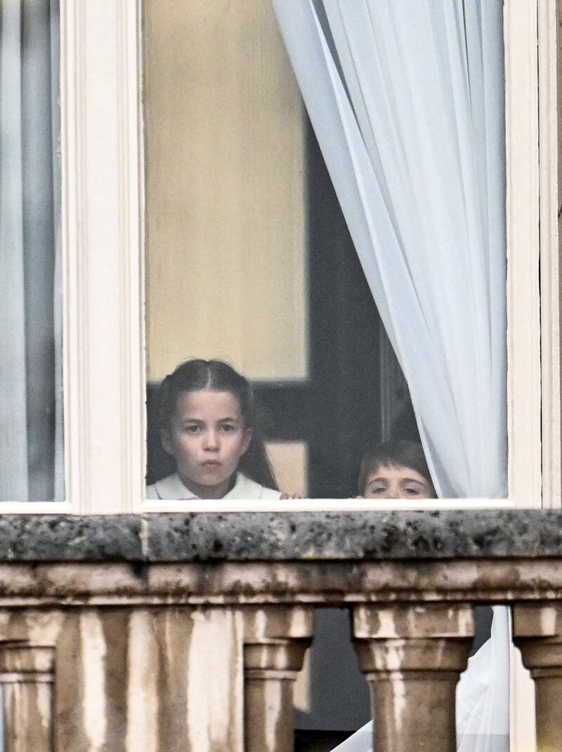 Princess Charlotte looks out of the window at Buckingham Palace.  Reuters