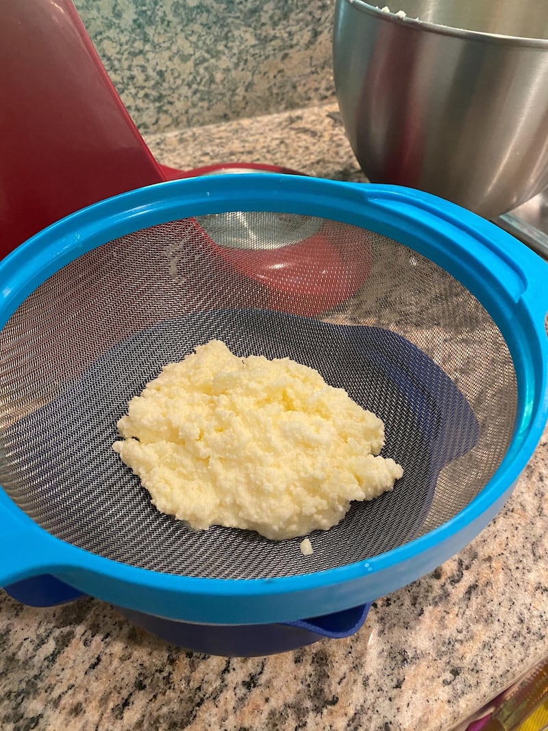 Separate the butter and buttermilk with a sieve. Not pictured: I then moved bowls and poured iced water over the butter and pressed the butter down, to ensure all liquid was out. Farah Andrews / The National