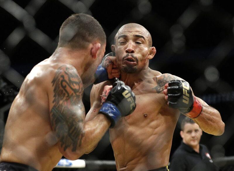 Frankie Edgar, left, hits Jose Aldo during their featherweight championship bout at UFC 200, Saturday, July 9, 2016, in Las Vegas. John Locher / AP Photo