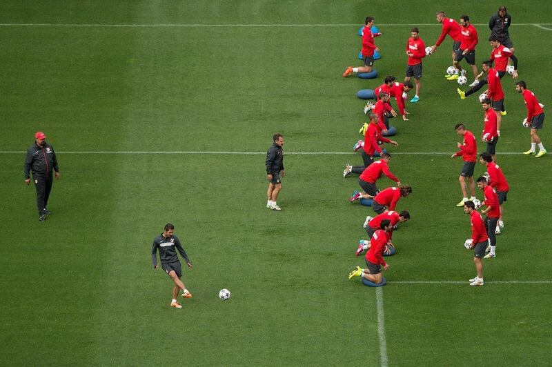 Diego Simeone strikes the ball as his players exercise during a training session held on Monday in anticipation of the Champions League final. Gonzalo Arroyo Moreno / Getty Images / May 19, 2014