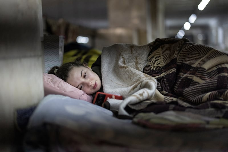 Masha, 26, checks her mobile phone at an air raid shelter inside a Kyiv metro station. Reuters