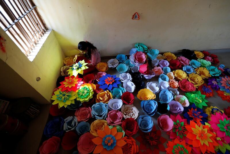A female inmate at Tihar Jail, the largest complex of prisons in South Asia, makes decorations for an event to mark International Women's Day in New Delhi,. Cathal McNaughton / AP Photo