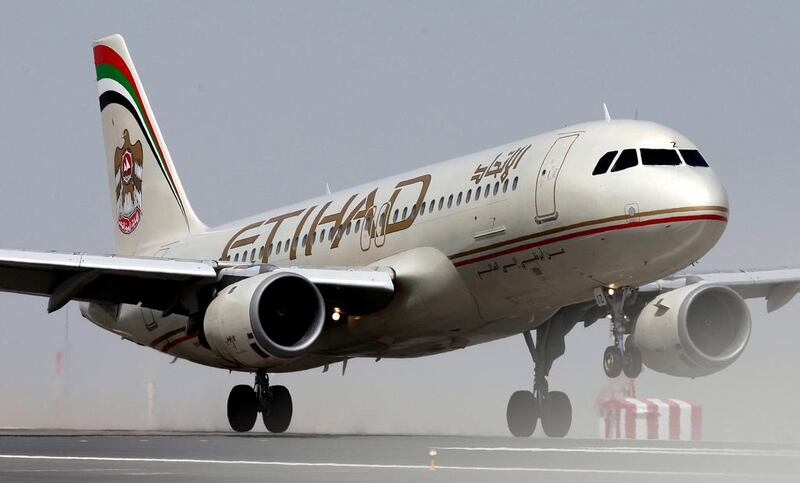 An Etihad A320 touches on the runway at Abu Dhabi Airport. Andrew Parsons / The National