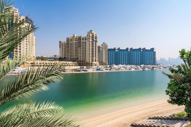The trunk of the Palm and Dubai Marina are visible from the garden.