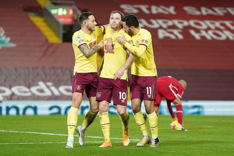 LIVERPOOL, ENGLAND - JANUARY 21: Ashley Barnes of Burnley celebrates with team mates (L - R) Josh Brownhill and Dwight McNeil after scoring their side's first goal during the Premier League match between Liverpool and Burnley at Anfield on January 21, 2021 in Liverpool, England. Sporting stadiums around the UK remain under strict restrictions due to the Coronavirus Pandemic as Government social distancing laws prohibit fans inside venues resulting in games being played behind closed doors. (Photo by Jon Super - Pool/Getty Images)