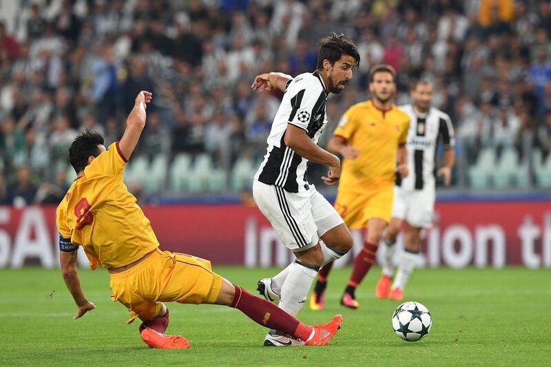 Juventus midfielder Sami Khedira tackled by Vicente Iborra of Sevilla FC. The match ended 0-0. Valerio Pennicino / Getty Images