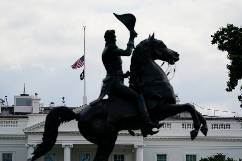 The American flag flies at half-mast over the White House. AP