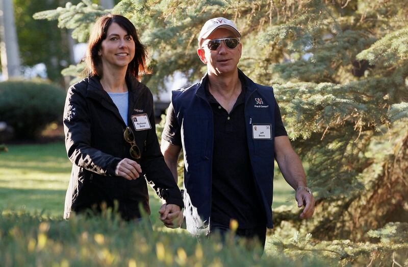 FILE PHOTO: Amazon CEO Jeff Bezos (R) and MacKenzie Bezos arrive at the annual Allen and Co. conference at the Sun Valley, Idaho Resort July 12, 2013.  REUTERS/Rick Wilking/File Photo