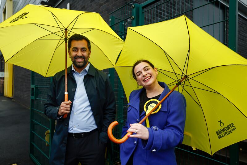 Scotland's First Minister Humza Yousaf joins Ms Loudon outside the booth. Getty Images