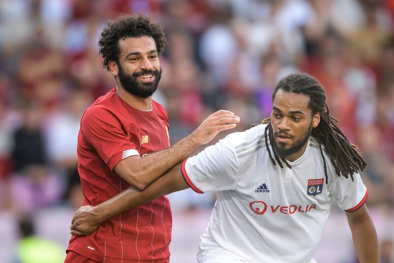 Liverpool's Egyptian midfielder Mohamed Salah (L) and Lyon's Belgian defender Jason Denayer vies during a pre-season friendly football match between Liverpool and Lyon on July 31, 2019 in Geneva.  / AFP / FABRICE COFFRINI
