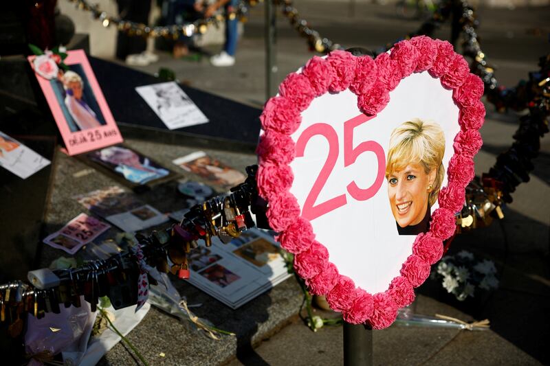 Pictures and flowers are left around the Liberty Flame monument in Paris. Reuters