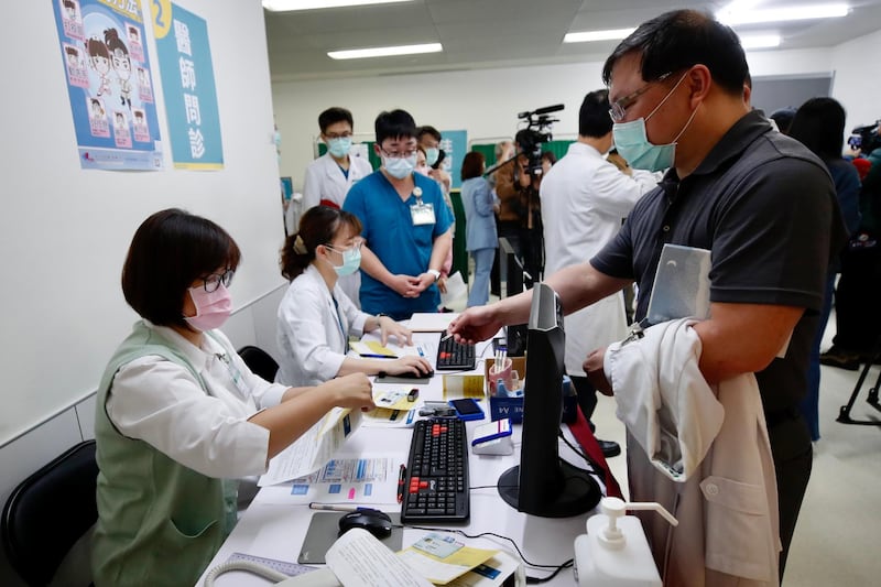 Taiwanese medical workers queue to receive the AstraZeneca Covid-19 vaccine in New Taipei City. Taiwan started administering AstraZeneca Covid-19 vaccines at 57 designated hospitals across the country. EPA