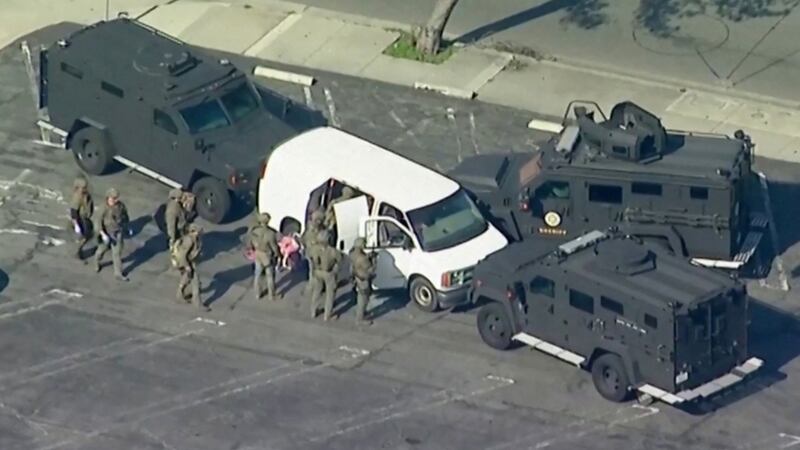 Police in Torrance, California, use armored vehicles to surround a white cargo van, believed to be connected to the Monterey Park mass shooting. Reuters