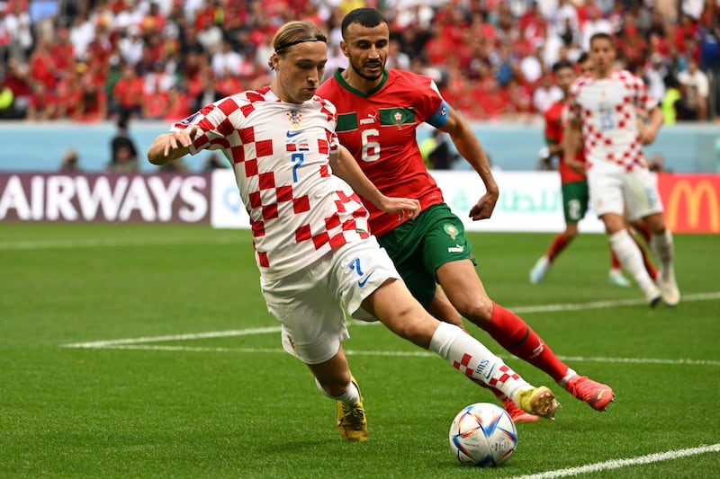 Croatia's Lovro Majer is challenged by Morocco captain Romain Saiss. Morocco were widely praised for holding the 2018 runners-up to a goalless draw. AFP