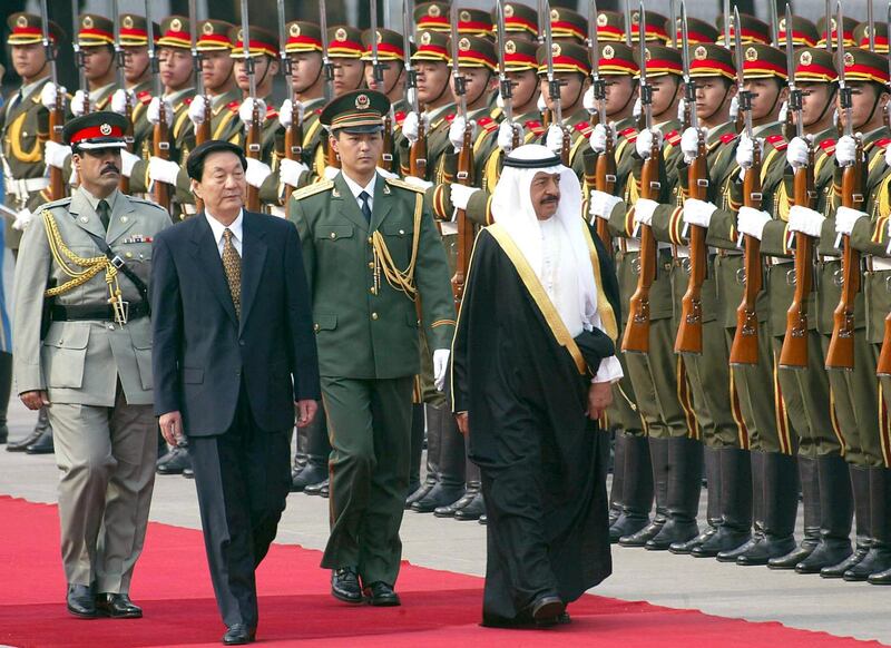 Chinese Premier Zhu Rongji  accompanies Bahrain's Prime Minister Khalifa bin Salman Al-Khalifa, as they review a guard-of-honour during a welcoming ceremony on Tiananmen Square, outside the Great Hall of the People in Beijing, 16 May 2002.   The Gulf kingdom of Bahrain is seeking to promote economic ties with China, as it embarked on democratic reform and held its first municipal elections since 1957, while is increasingly looking East.             AFP PHOTO/GOH Chai Hin (Photo by AFP)