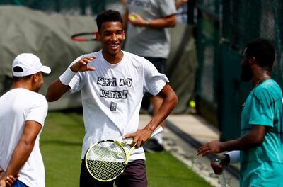 epa07684686 Felix Auger Aliassime (C) from Canada in action during a training session for the Wimbledon Championships at the All England Lawn Tennis Club, in London, Britain, 30 June 2019. EPA/NIC BOTHMA EDITORIAL USE ONLY/NO COMMERCIAL SALES