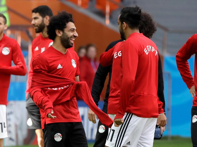 Egypt's Mohamed Salah, left, jokes with teammates during Egypt's training session. Mark Baker / AP Photo