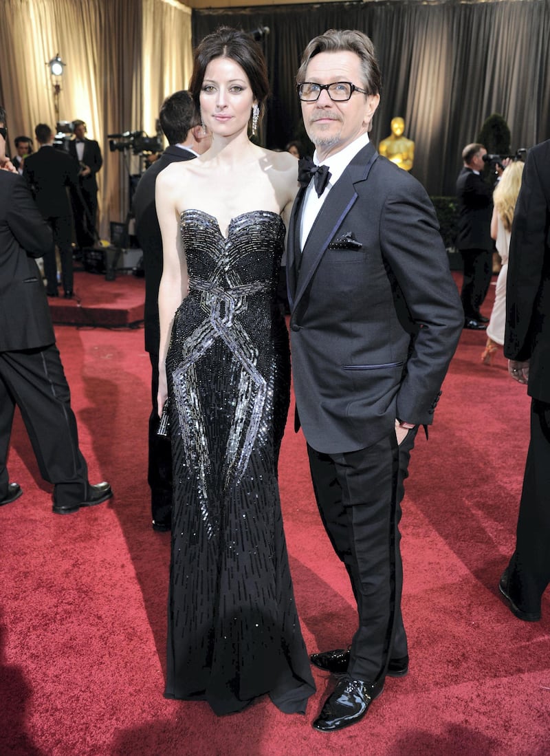 HOLLYWOOD, CA - FEBRUARY 26: Actor Gary Oldman (R) and Alexandra Edenborough arrive at the 84th Annual Academy Awards held at the Hollywood & Highland Center on February 26, 2012 in Hollywood, California.   Ethan Miller/Getty Images/AFP