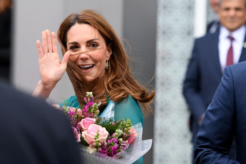 Britain's Catherine, Duchess of Cambridge gestures to the crowd as she leaves the Aga Khan Centre in London. AFP