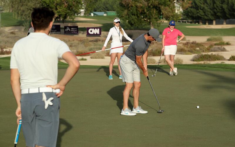 Rory McIlroy of Northern Ireland plays a shot watched by Niall Horan, Paige Spiranac and Saoirse Lambe during the pro-am. David Cannon / Getty Images