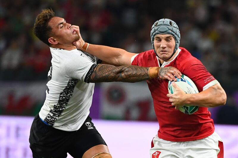 Wales' centre Jonathan Davies (R) runs with the ball past Fiji's centre Jale Vatubua during the Japan 2019 Rugby World Cup Pool D match between Wales and Fiji at the Oita Stadium in Oita. AFP