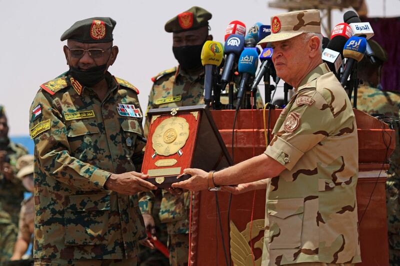 (L to R) Sudanese Chief of Staff Lieutenant General Muhammed Othman al-Hussein and his Egyptian counterpart Mohammed Farid pose for a picture speaks after concluding the "Guardians of the Nile" joint military drill in Sudan's southern Kordofan state on May 31, 2021.  / AFP / ASHRAF SHAZLY
