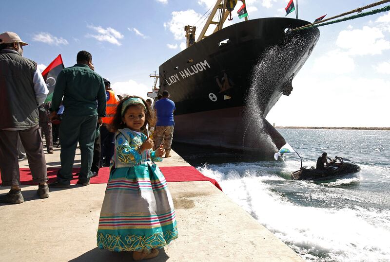A Libyan girl poses for a photo at the Benghazi port, which was closed for the past three years due to rebel groups occupying the eastern Libyan city, during a ceremony marking the re-opening of the port on October 1, 2017
Benghazi's commercial port re-oped after a three year halt in activities due to the conflict in the city which was the cradle of the popular revolt that ended the regime of Moamer Kadhafi in 2011. / AFP PHOTO / Abdullah DOMA