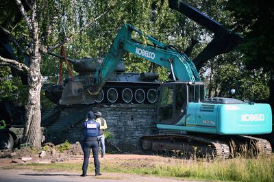 Workers remove a Soviet T-34 tank installed as a monument in Narva, Estonia. AP