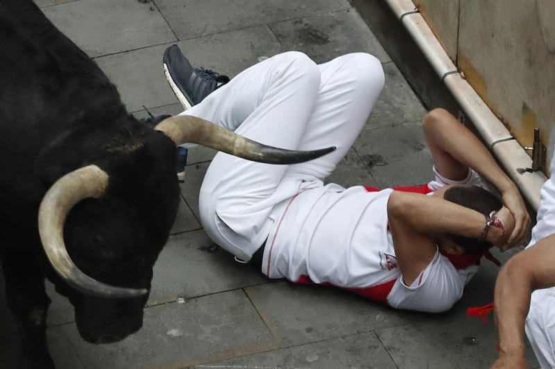 Five people— four Americans and a Spaniard— have been gored since the bull runs started Friday. Javier Lizon / EPA