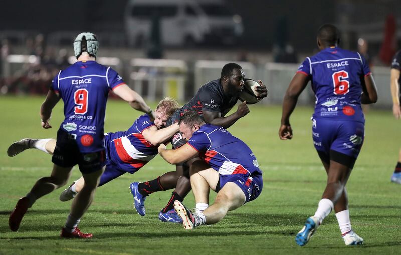 Dubai Exiles Brad Owako is tackled during the game against Jebel Ali Dragons. Pawan Singh / The National   