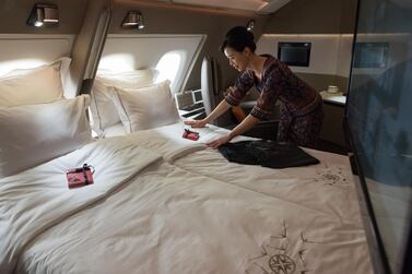 An air stewardess arranges a double bed in a suite of Singapore Airlines' Airbus A380 at Changi Airport in Singapore. The airline is offering a pre-dining restaurant tour, with access to private areas, including the cockpit, in novel ways to raise money. AFP