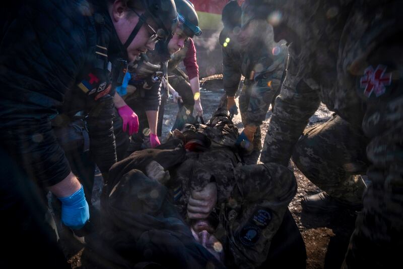 Paramedics transfer a Ukrainian soldier wounded at the Bakhmut front line to a field hospital. EPA