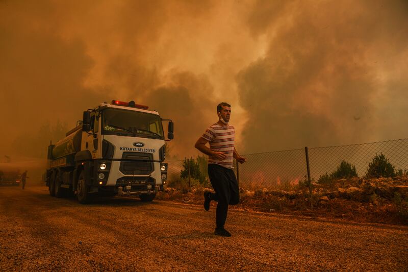 A man flees the flames in Sirtkoy.