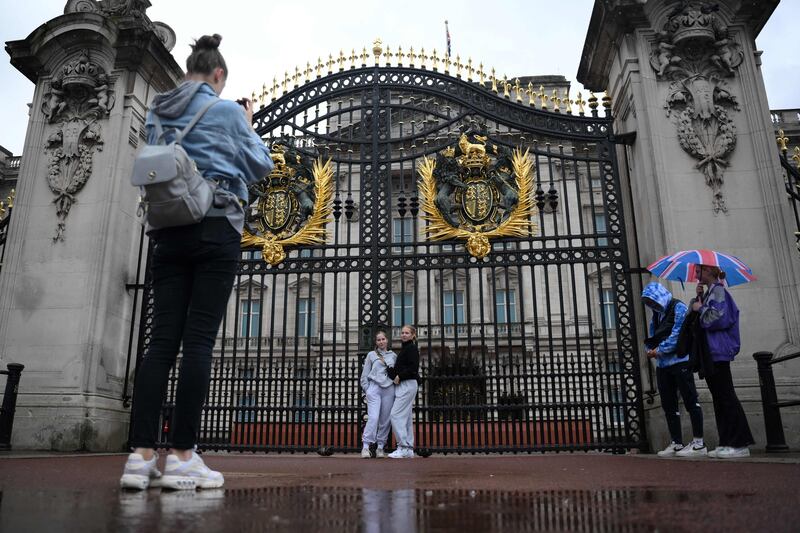 Tourists at Buckingham Palace. AFP