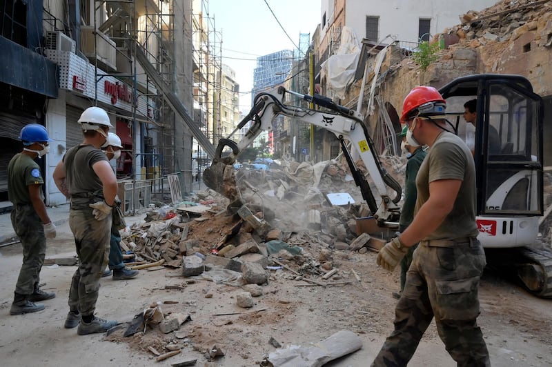 epa08717034 Members of UN peacekeepers (UNIFIL) help clear the ruins at Mar Mikhael neighborhood, following a huge explosion rocked the city in Beirut, Lebanon, 03 October 2020. At least 190 people were killed, and more than six thousand injured in the Beirut blast that devastated the port area on 04 August and believed to have been caused by an estimated 2,750 tons of ammonium nitrate stored in a warehouse. The explosion damaged some 50 thousand housing units, and left 300 thousand people homeless. Preparations for the restoration of partially damaged buildings began in the areas of Karantina, Gemmayze, and Mar Mikhael facing the port of Beirut.  EPA/WAEL HAMZEH