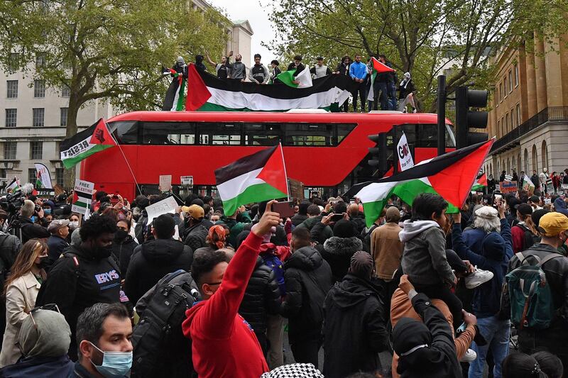 Pro-Palestinian protesters stop a London bus in central London. AFP