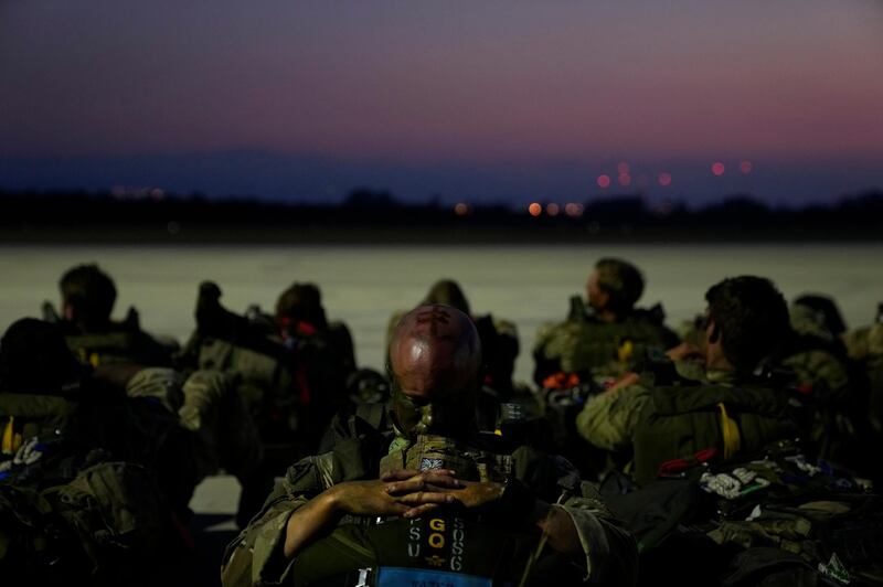 British paratroopers with the 16th Air Assault Brigade sit on the apron at RAF Akrotiri air base in Cyprus waiting to board a C130 transport aircraft for an airdrop over Jordan as part of a joint exercise with Jordanian soldiers. AP