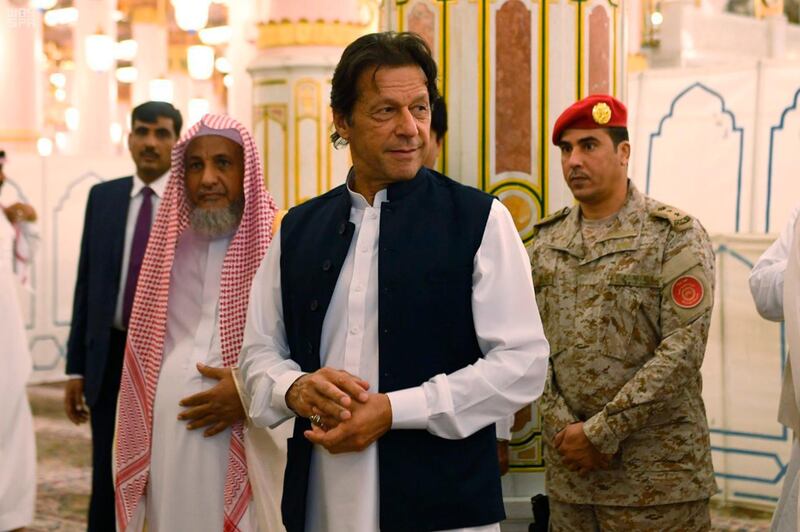 In this Tuesday, Sept. 18, 2018, photo released by the state-run Saudi Press Agency, Pakistani Prime Minister Imran Khan, center, visits the Prophet's Mosque in Medina, Saudi Arabia. Khan, a former cricketer, is on a tour of Saudi Arabia and the United Arab Emirates as part of his first overseas trip since taking office. (Saudi Press Agency via AP)