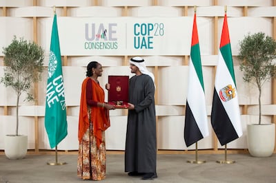 Dr Agnes Kalibata, president of Agra and a Cop28 presidency advisory committee member, receives the First Class Order of Zayed II medal from President Sheikh Mohamed. Photo: Presidential Court 