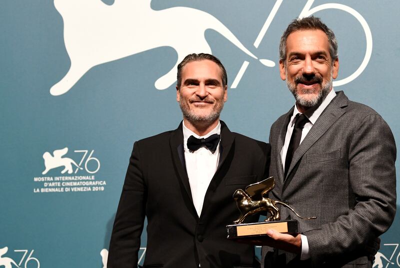 The 76th Venice Film Festival - Awards Ceremony - Venice, Italy, September 7, 2019 - Director Todd Phillips poses next to Joaquin Phoenix with the Golden Lion for Best Film. REUTERS/Piroschka van de Wouw