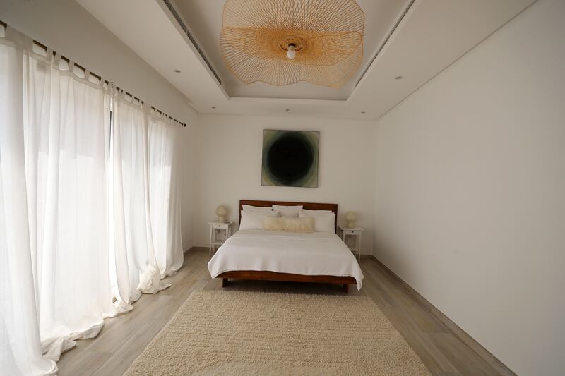 The master bedroom is a more muted space and Bowen's 'Vortex' hangs above the bed. 