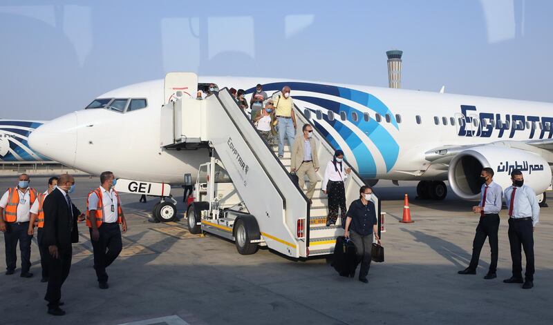 Passengers leave an EgyptAir plane at Cairo International Airport, Egypt. According to reports, all passengers arriving to Egypt airports are required to provide a negative PCR test for coronavirus as of 01 September. However foreign tourists landing at Hurghada, Sharm El-Sheikh, Marsa Alam can undergo the test upon arrival at the airports for 30 US dollars  EPA