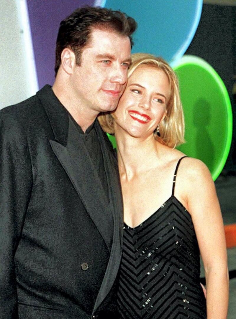 US actor John Travolta (L) and his actress-wife Kelly Preston pose for photographers as they arrive for the Inaugural Screen Actors Guild Awards Show 25 February in Los Angeles. Travolta was nominated for outstanding performance by a male actor in a leading role for his part in "Pulp Fiction." 
 (COLOR KEY: BAckground is blue and green) AFP PHOTO (Photo by VINCE BUCCI / AFP)