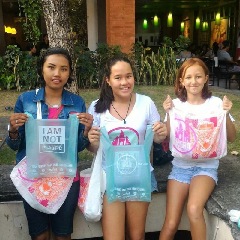 Girls hold biopolymers bags made from cassava will degrade into harmless substances as litter. Courtesy Avani