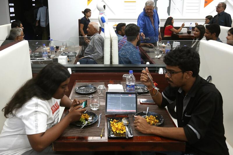 People use a tablet to order food at Robot. EPA