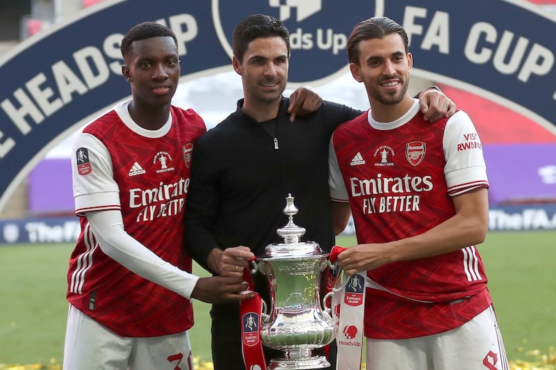 Arsenal's head coach Mikel Arteta poses with Dani Ceballos, right, and Eddie Nketiah. AP